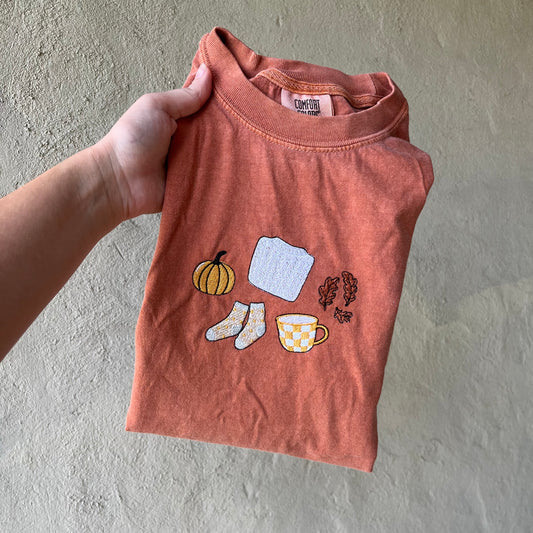 Comfort Colors fall t-shirt with embroidered pumpkin, sweater, socks, coffee, and leaves design